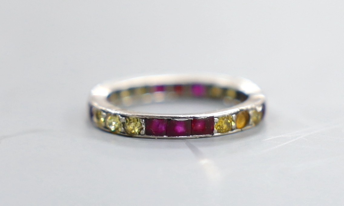 A white metal and gem set eternity ring, size L/M, gross weight 2.6 grams.